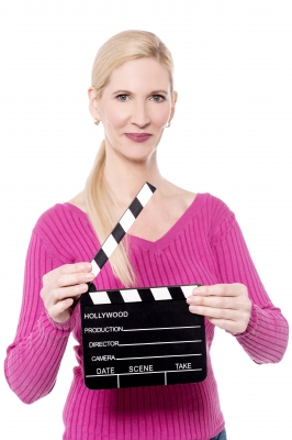 Woman holding clapper board