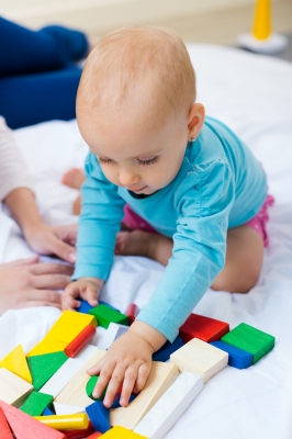 Baby playing with mother