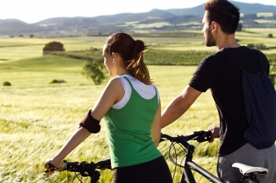 Man and woman on bikes in countryside